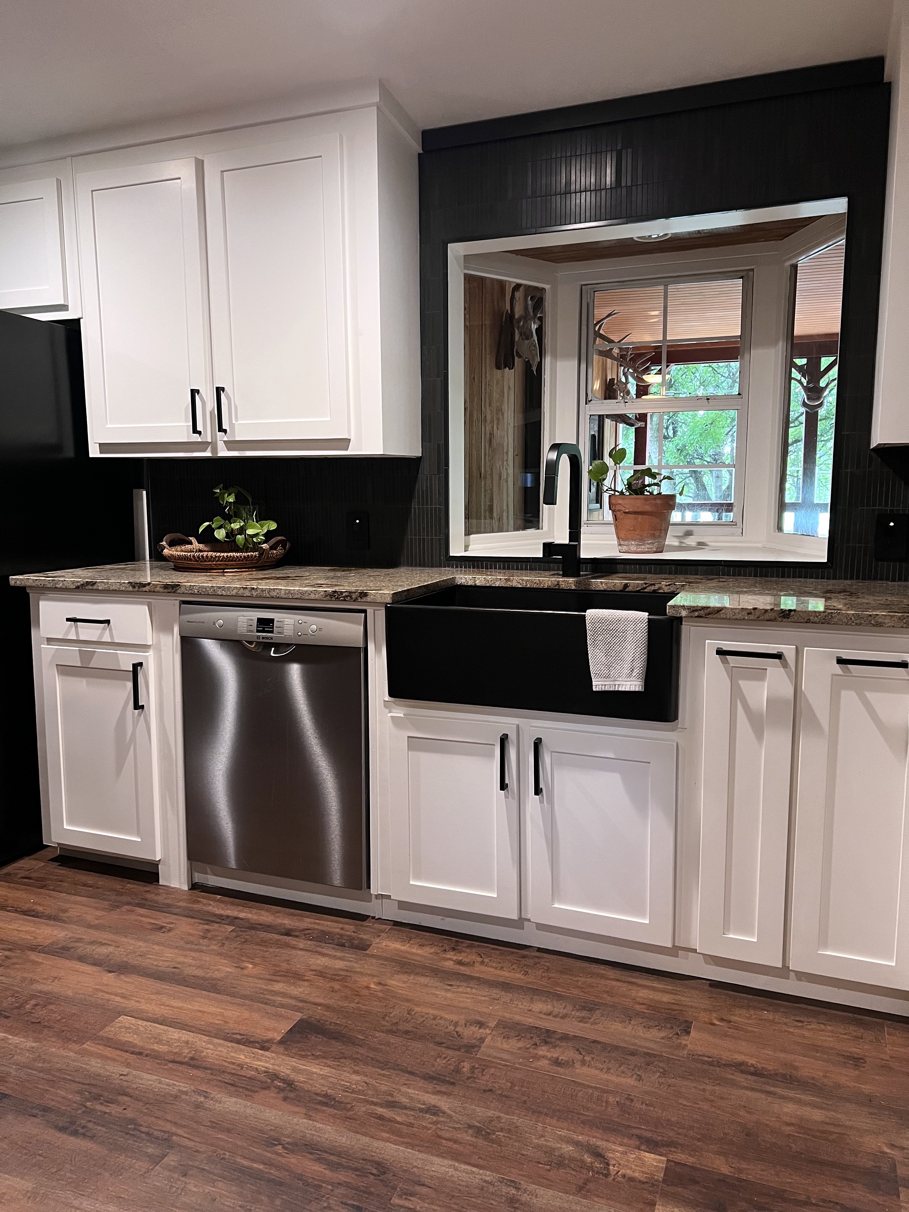 Buckhorn kitchen after — sink wall and wall oven tower together showing dishwasher, farmhouse sink and new appliance column