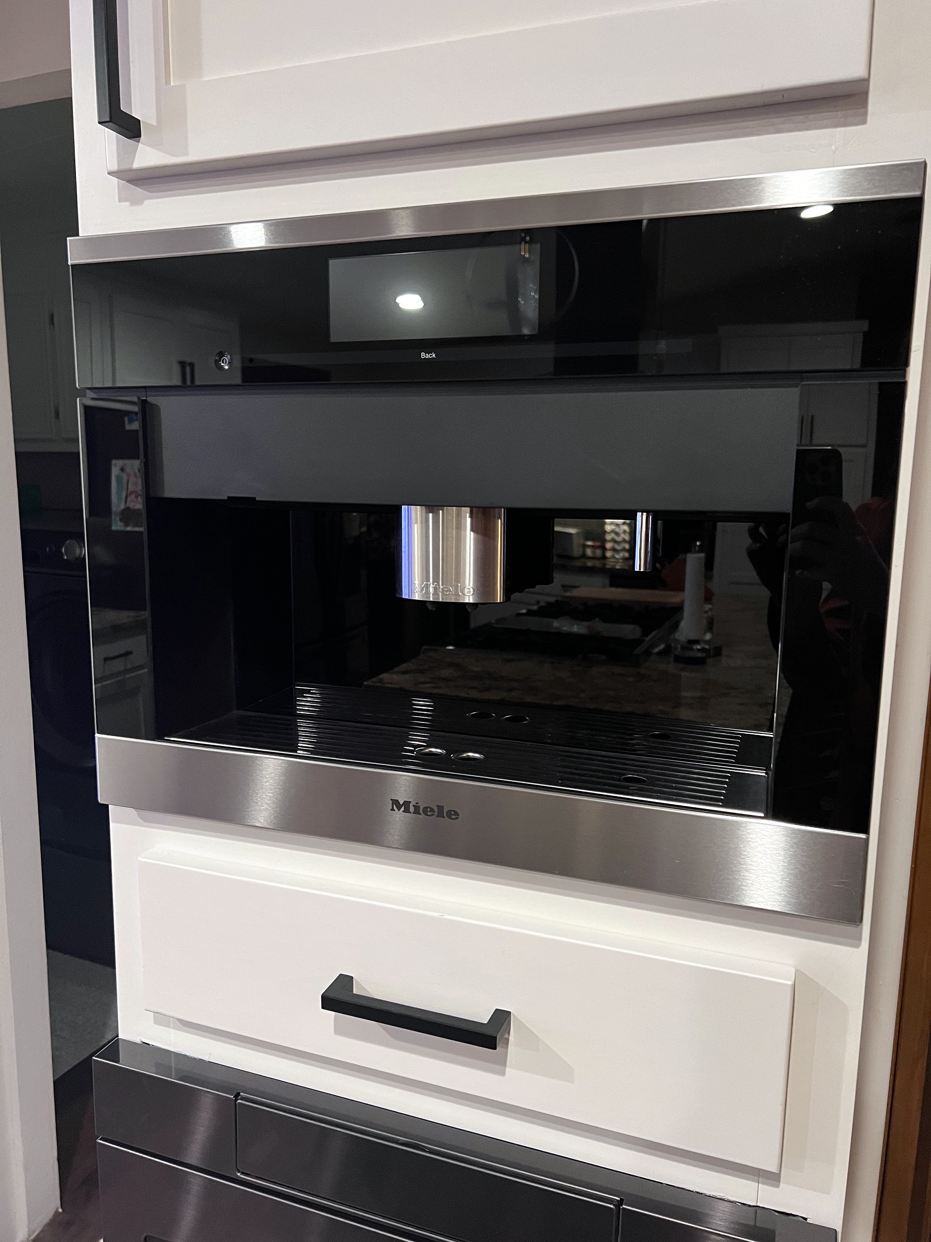 Buckhorn kitchen after — built-in Miele coffee station in white cabinetry column