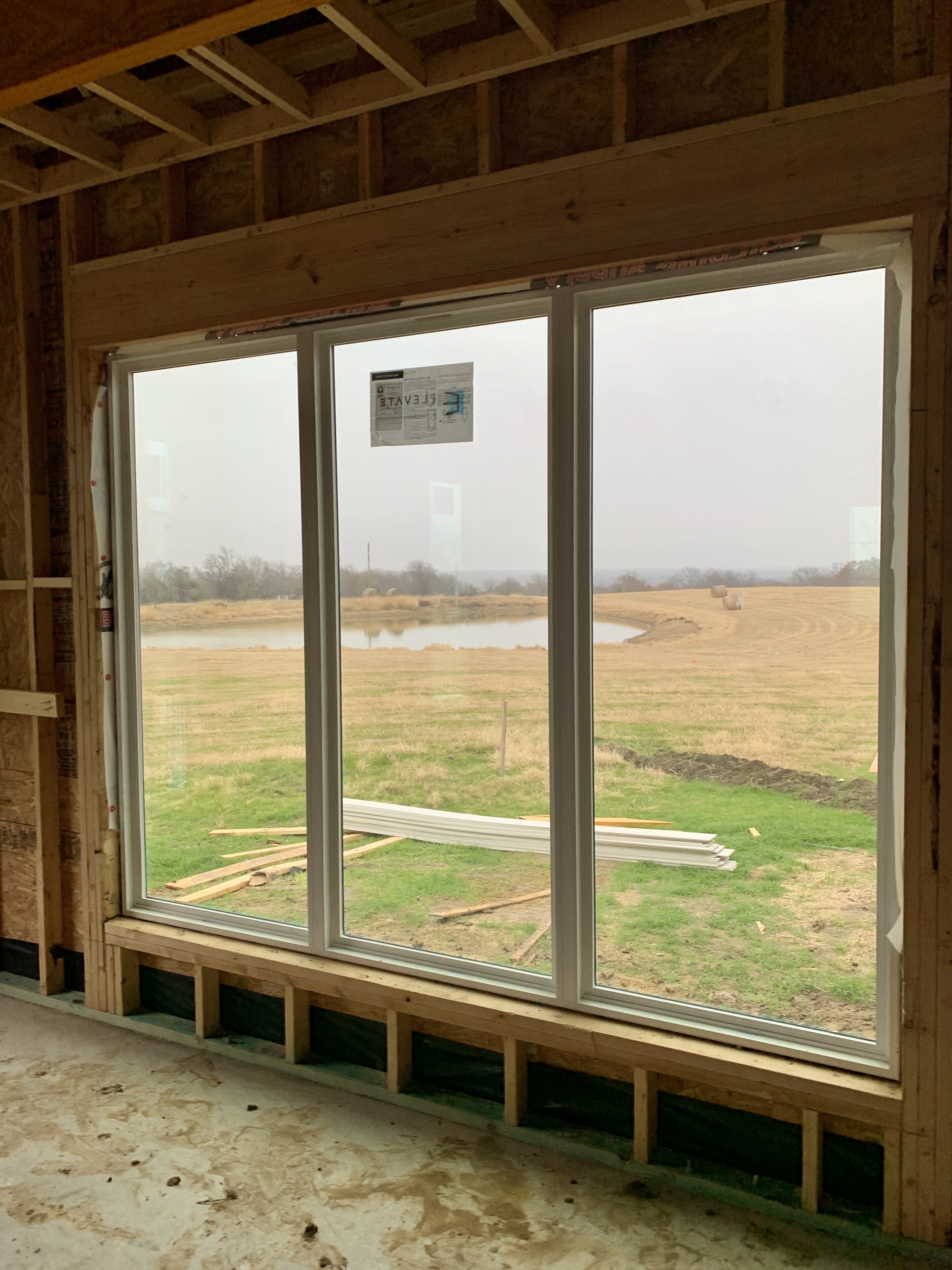 Old Gin new build — pond-view windows being installed