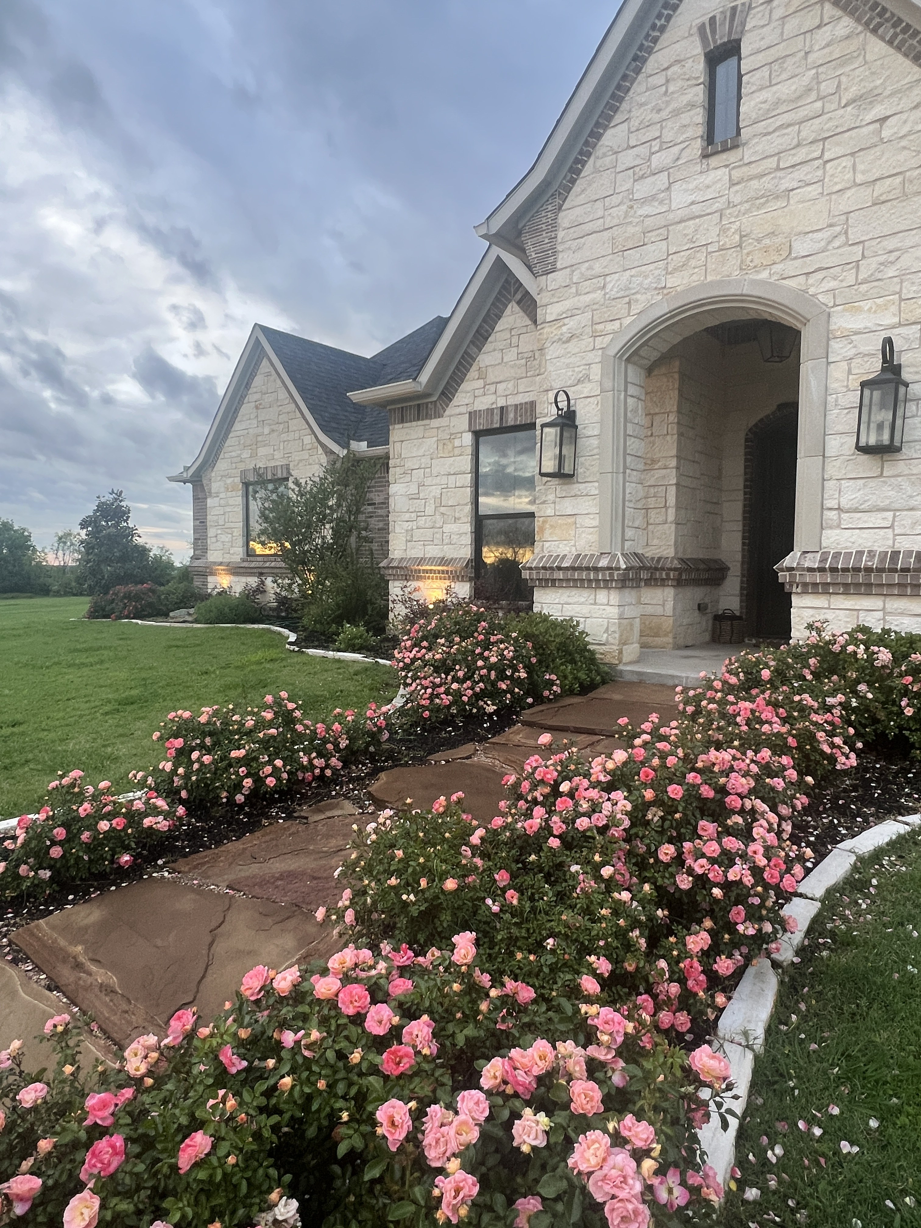 Old Gin new build — front entry with rose garden and lantern sconces