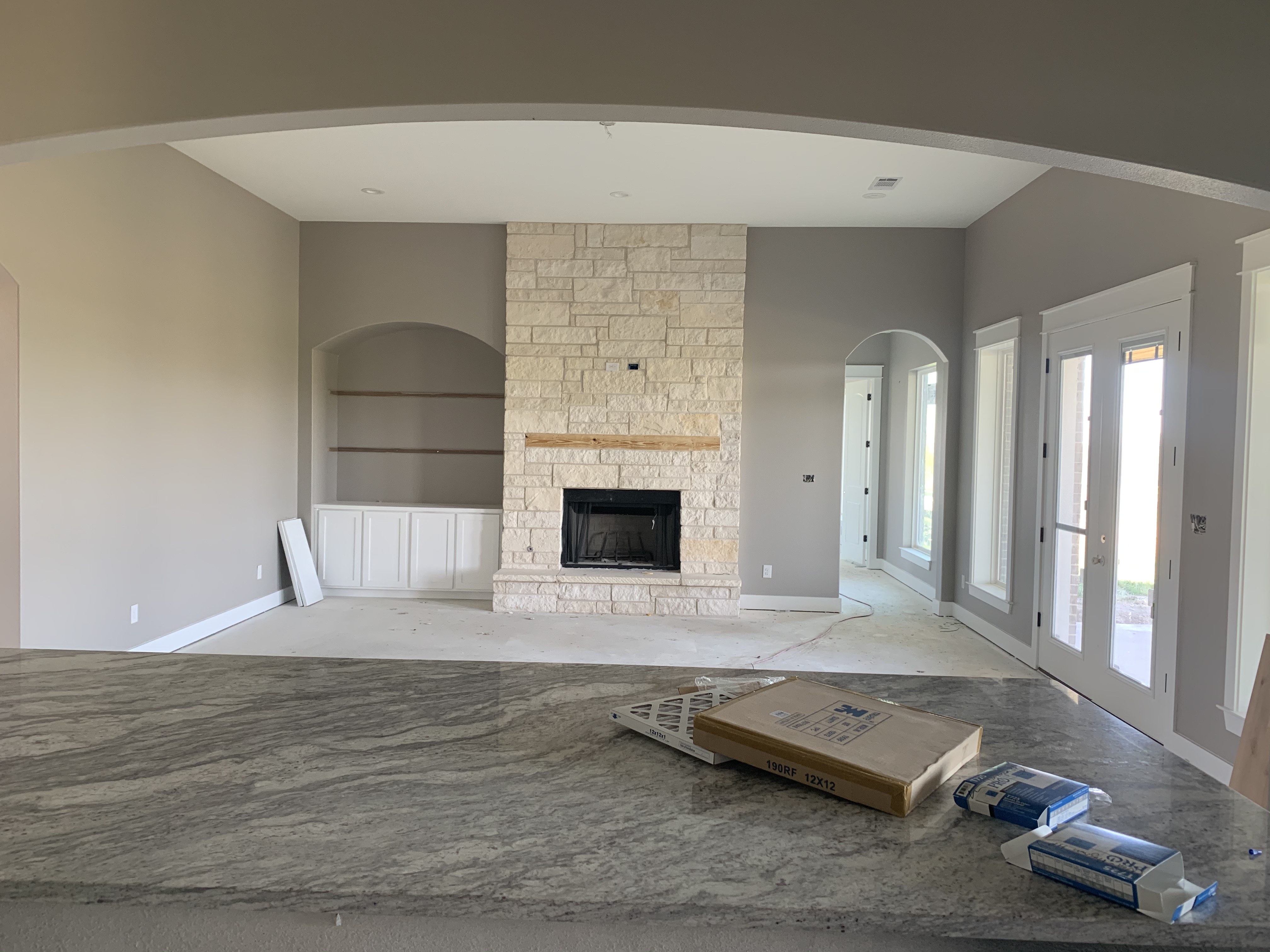 Old Gin new build — interior near completion with natural light and stone fireplace