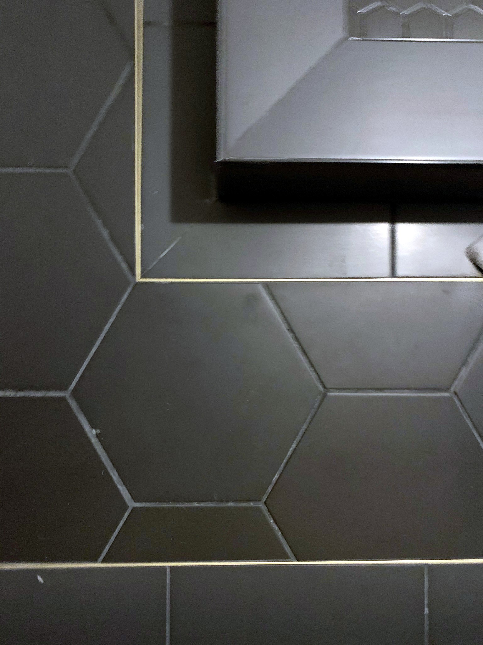 Summer Glen renovation — hex tile floor detail with gold trim