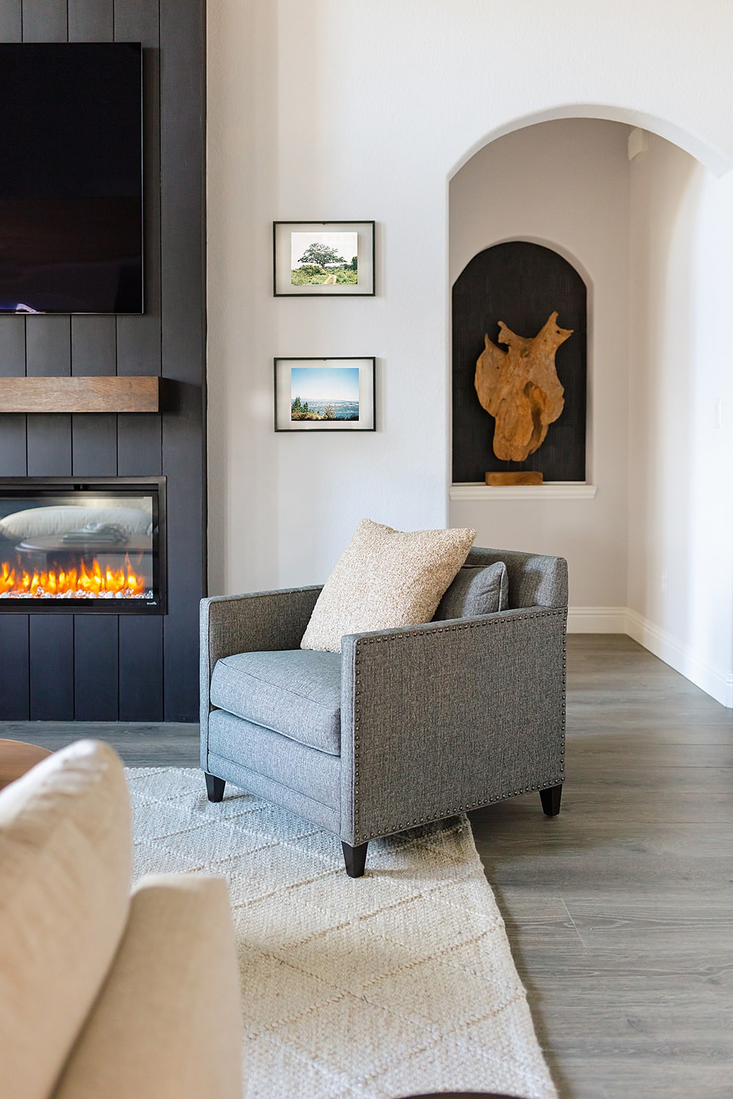 Strait Lane living room — fireplace detail and accent chair