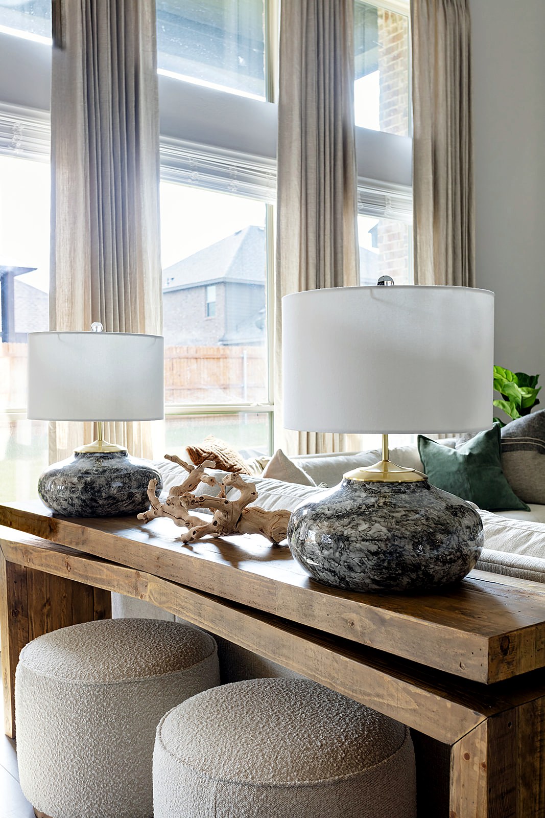 Strait Lane — console table with rock lamps, bouclé ottoman and custom drapery