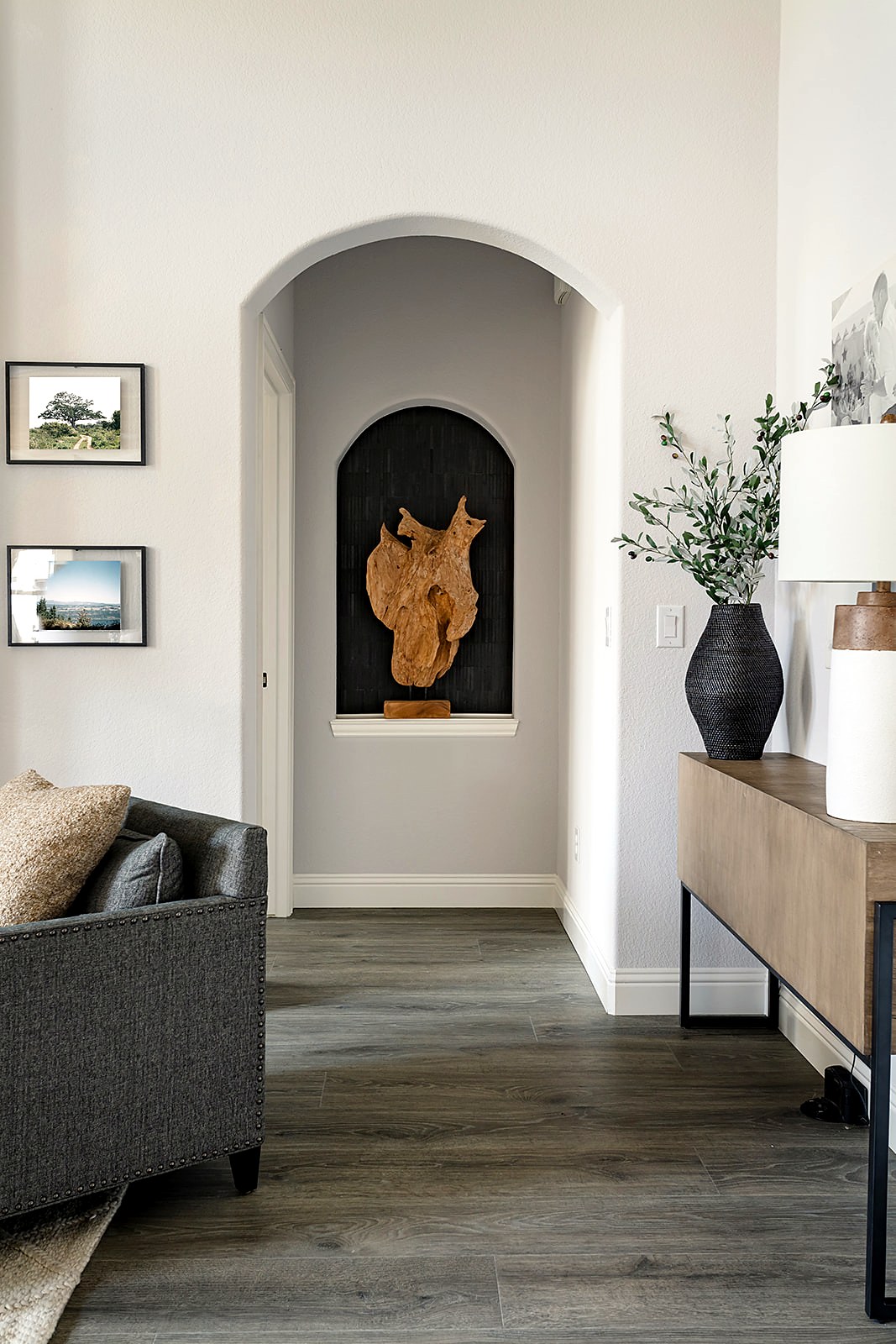 Strait Lane — black tile niche with modern rustic wood sculpture