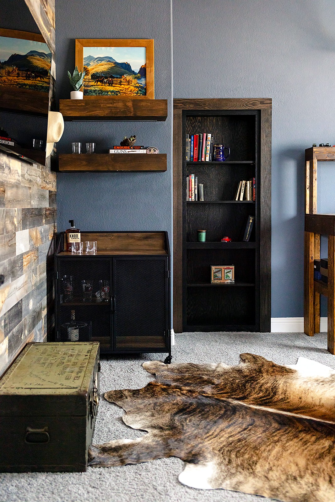 Strait Lane man room — rustic mancave with whiskey bar, cowhide and accent wall