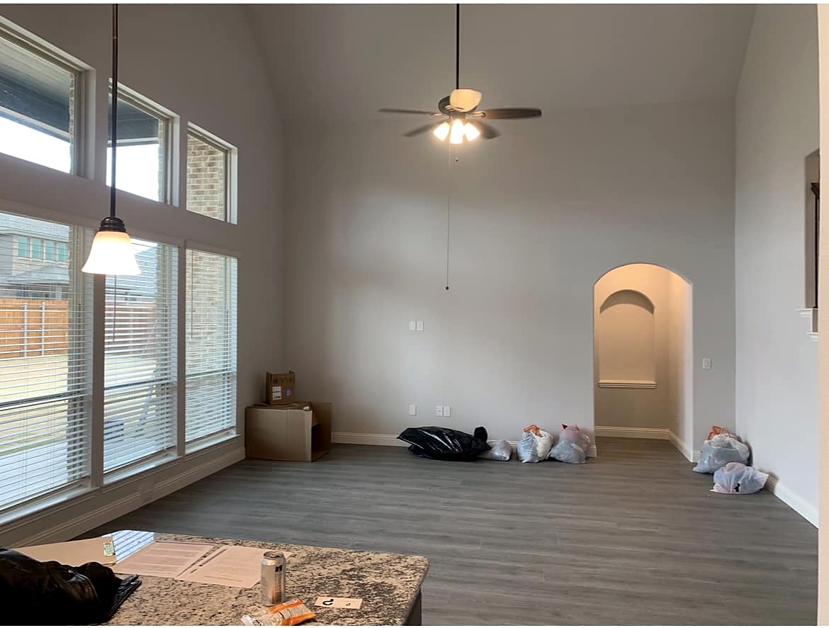 Strait Lane before — builder-basic living room and kitchen