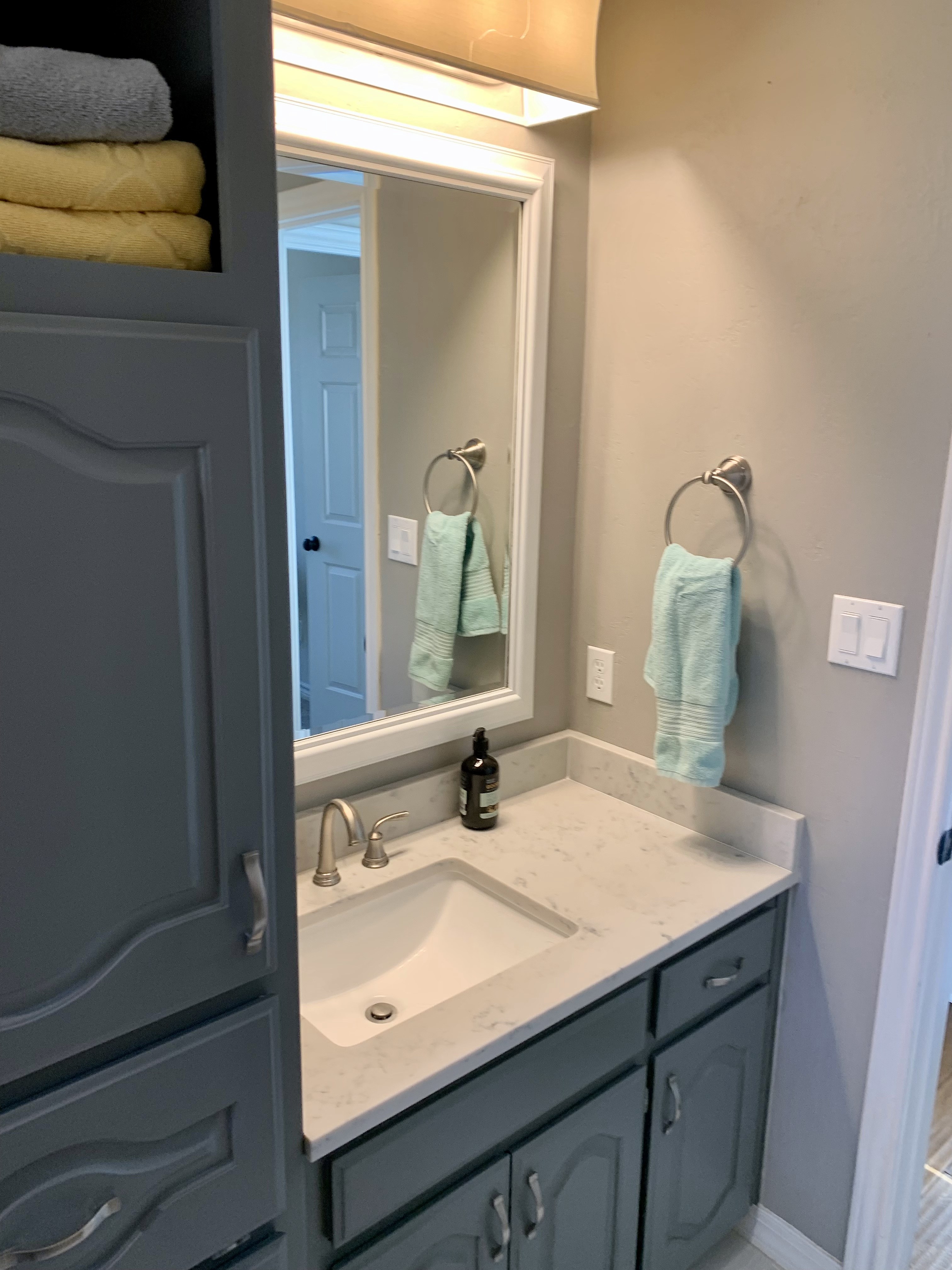 Shady Oaks — feminine bathroom before renovation, original vanity with marble countertop and single sink