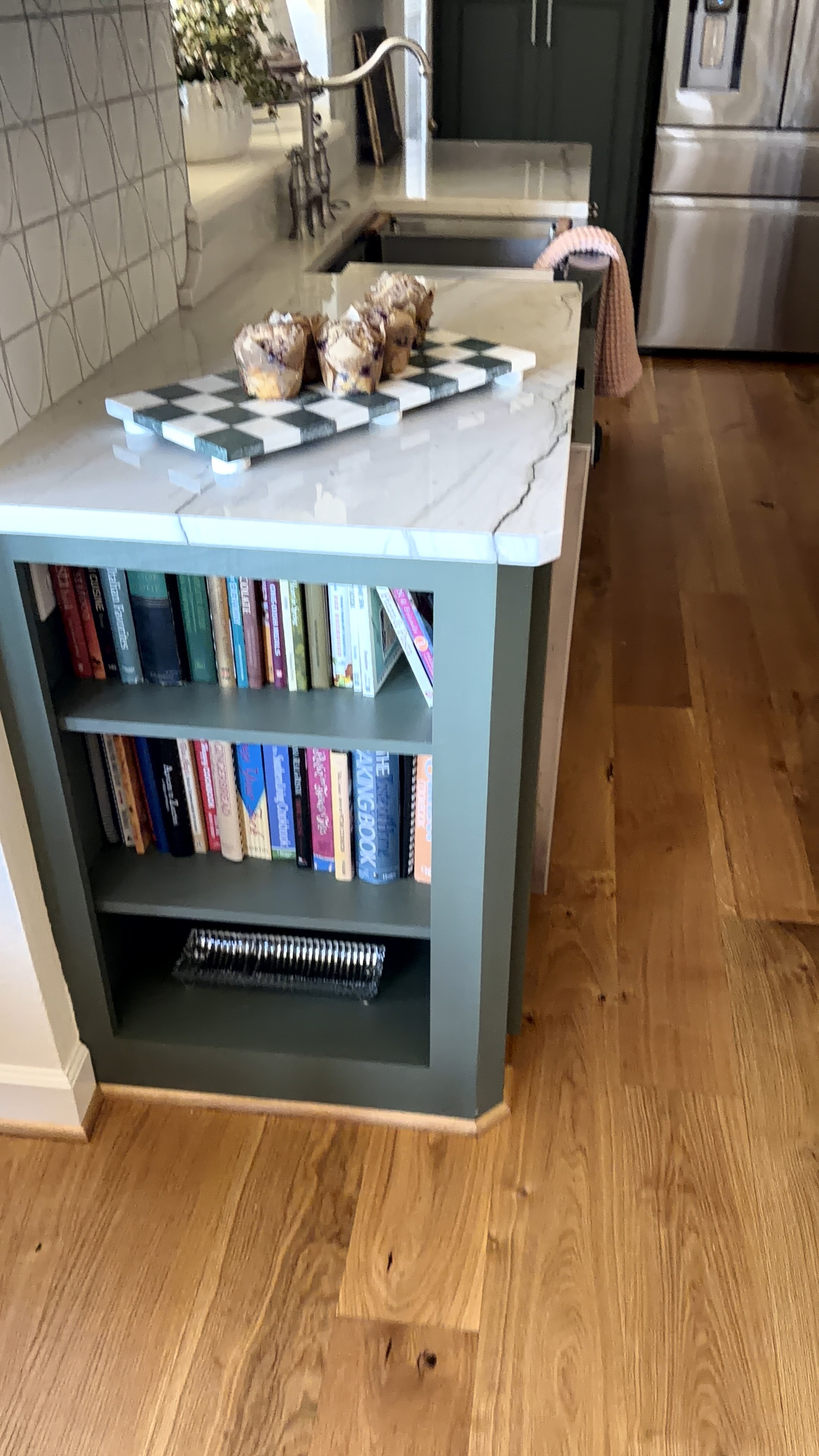 Sugar Ridge kitchen — island end with built-in bookshelf and marble countertop